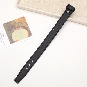 Detail of black leather phone wrist strap with metal rivet and adjustable holes