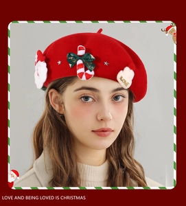 Detail of red wool beret with Santa, candy cane, and LOVE knit hat ornaments