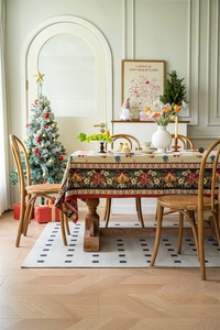 Close-up of festive Christmas jacquard tablecloth with poinsettia and bell patterns