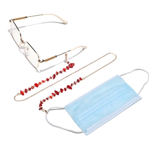 Detailed view of gold chain with red stone beads for glasses and face masks