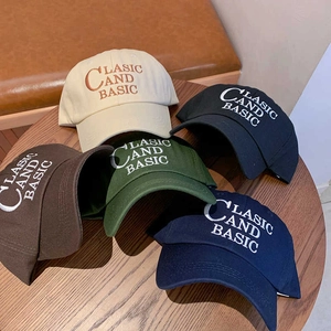 Classic cotton baseball caps in five vintage colors with embroidery on a wooden table