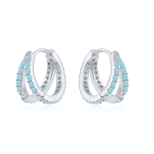 Macro detail of silver double-row hoop earrings featuring pavé set turquoise blue stones