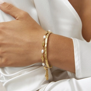 18k gold plated stainless steel hammered cuff bracelet and pearl chain set on wrist