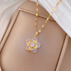 Luxurious gold flower necklace set with clear zircon stones on elegant velvet display