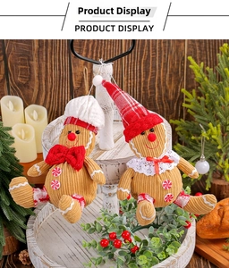 Close-up of gingerbread man plush ornaments hanging on a rustic festive background