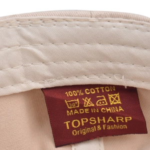 Detail view of cotton baseball cap inner lining with red wash label and stitching