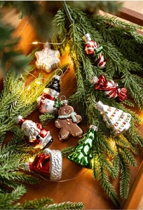 Detailed view of colorful Christmas glass ornaments on pine branches and wooden tray