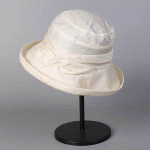Detail of ivory Lyocell-linen sun hat featuring a delicate bow with pearl embellishments