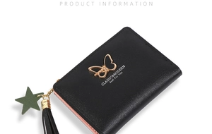 Detail of bifold wallet with gold butterfly, black tassel and star charm