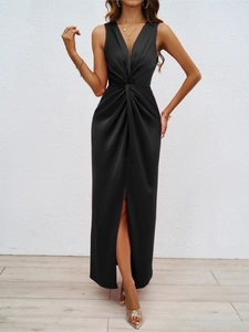 Close-up of elegant black sleeveless V-neck dress featuring waist twist and side slit detail