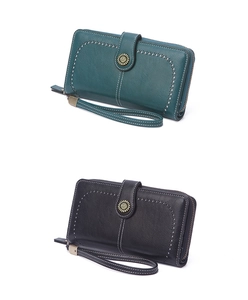 Close-up of leather long wallet with wristlet strap and metallic snap button details
