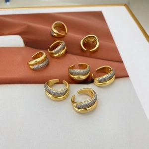 Macro view of 18K gold irregular rings with double-row zircon pavé on artistic background