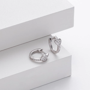 Detailed macro view of S925 sterling silver heart earrings with sparkling cubic zirconia