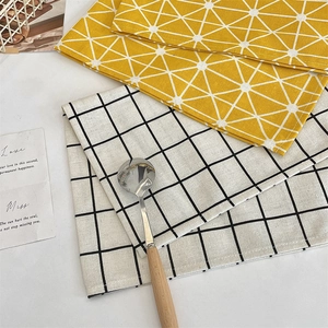 Detail view of cotton linen placemats with geometric patterns and heat-resistant texture