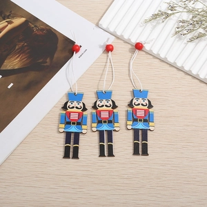 Detailed view of three handcrafted wooden nutcracker soldier ornaments with cotton cords