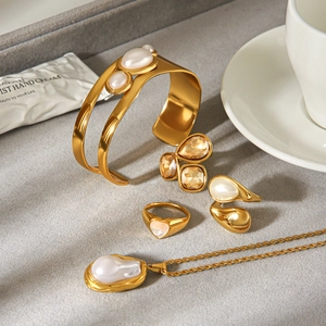 Golden stainless steel jewelry set with white stone rings and baroque pearl necklace