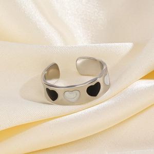 Adjustable silver heart ring with black and white enamel pattern on silk background