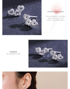 Macro detail of silver butterfly earrings with cubic zirconia micro-inlay accents