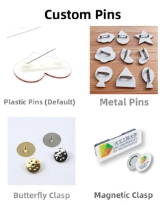 Detail view of custom badge backs with plastic pins, metal butterfly clips, and magnetic clasps