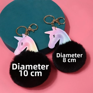 Detalle de los llaveros de unicornio brillante de 8cm y 10cm con pompones de pelo negro