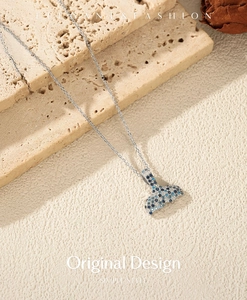 Macro shot of S925 sterling silver mermaid tail necklace with gradient blue zircon stones