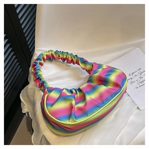 Detail of a pleated rainbow gradient dumpling bag with a silky finish and soft handle