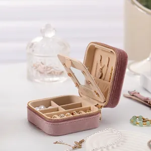 Pink velvet portable jewelry organizer with zipper closure and multi-functional compartments