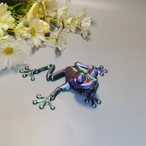 Detail view of a 3D printed articulated frog with iridescent purple and green metallic finish