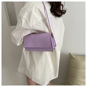 Minimalist light purple woven texture shoulder bag for women worn by a model in white shirt