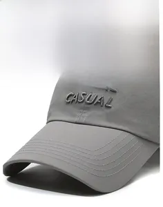 Detail of grey quick-dry baseball cap with CASUAL embroidery and reinforced brim stitching