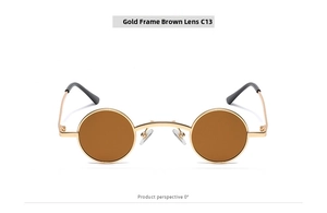 Detail of round gold metal frame sunglasses with tea-colored lenses and black ear tips