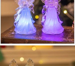 Detail of LED acrylic angel lamps in blue and purple light on vintage books background