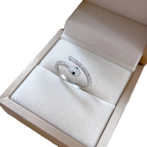 Silver snake wrap ring with green crystal eyes in a premium jewelry display box