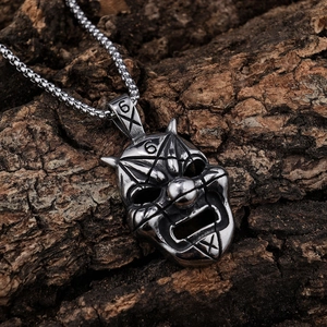 Vintage silver Viking style Slipknot clown mask pendant on a dark rustic wood background