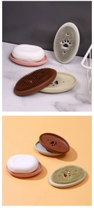 Close-up of silicone soap dish with integrated cleaning brush and paw-shaped drain holes