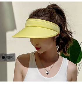 Detail of yellow wide brim sun visor hat with Enjoy Sunshine text on outdoor model