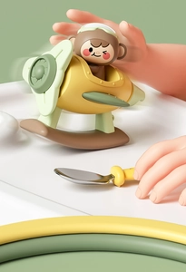 Detail of cartoon monkey pilot on yellow toy airplane with green wings for toddlers