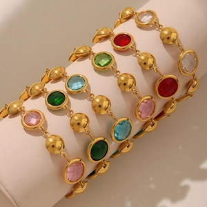 Luxurious gold chain bracelet featuring vibrant round cut multi-colored gemstones on a display
