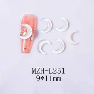 Detail of 9x11mm pearl white moon nail charms on a soft glitter manicure base