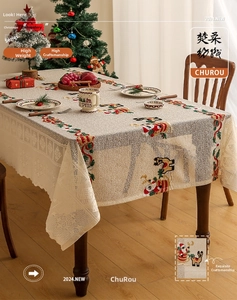 Close-up of Santa Claus and reindeer embroidery with delicate lace edges on table cloth