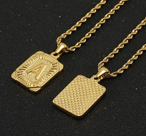Detailed view of the double-sided golden letter A pendant with a twisted chain design