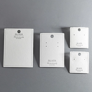 Detailed view of white jewelry display cards for necklaces and earrings with S925 print