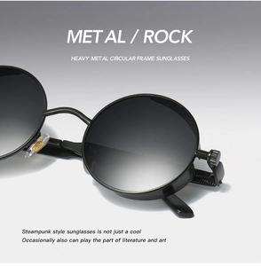 Detail of steampunk black round metal sunglasses with industrial texture and spring hinge
