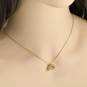 Luxurious gold-plated necklace with a micro-paved cubic zirconia letter P pendant on model