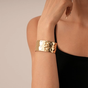 Polished gold hammered wide cuff bracelet with irregular texture and open C-shape design