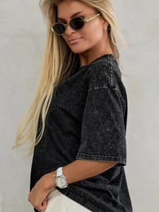 Detail of vintage washed black cotton T-shirt showing acid wash texture and drop shoulder