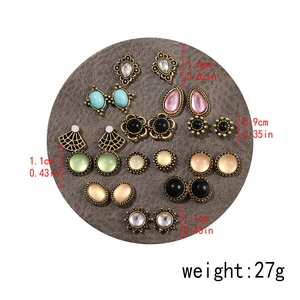 Detailed set of 12 vintage-style earrings featuring assorted resin stones and pearl accents