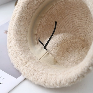 Winter plush bucket hat in off-white with warm fleece texture and adjustable inner drawstring