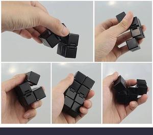 Macro view of a black infinity cube showing smooth hinges and folding mechanism for stress relief