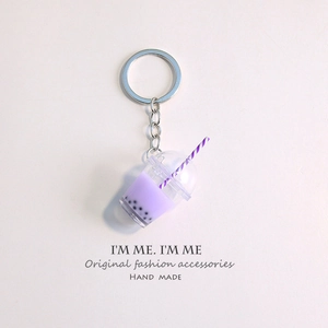 Detailed close-up of a purple bubble tea keychain with miniature straw and black pearls